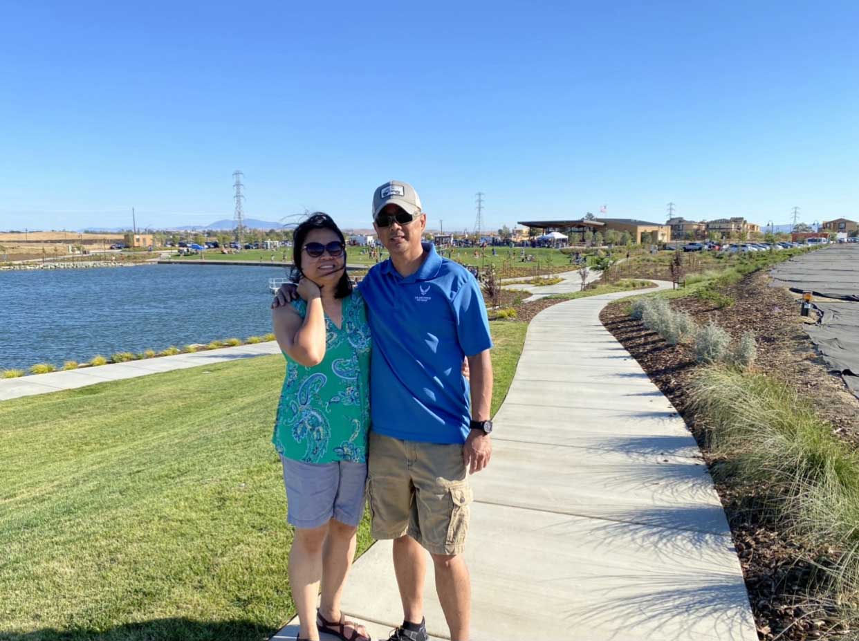 Couple on walking path along side lake